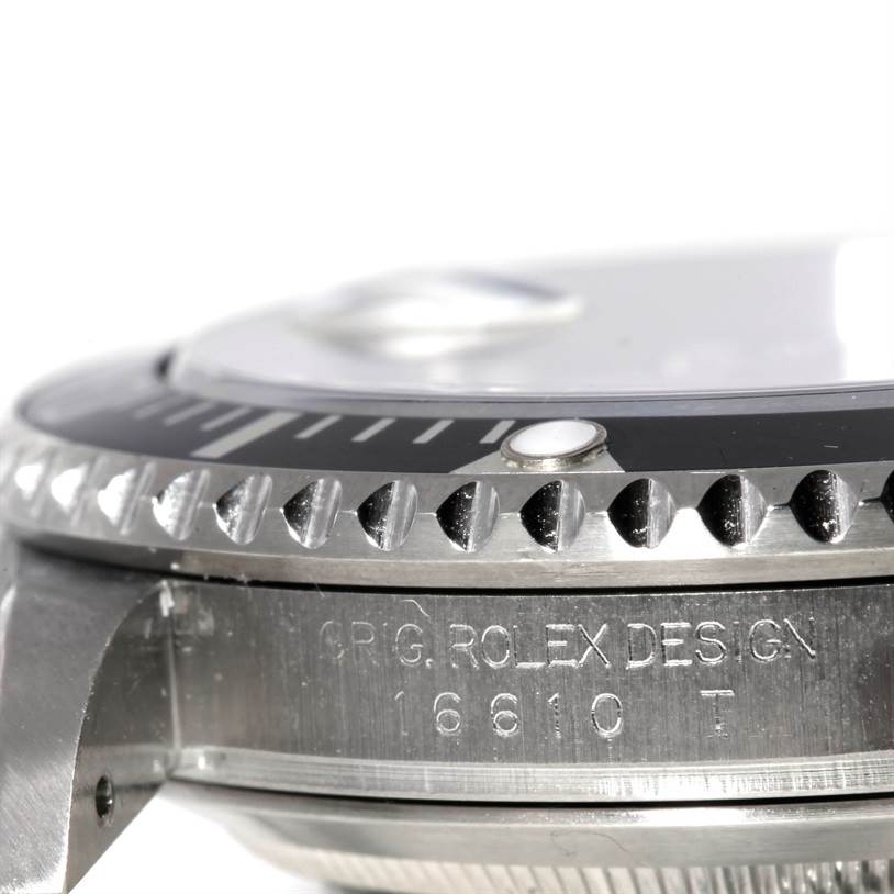 This image shows a close-up side view of the bezel and case of a Rolex Submariner 16610 Men
s Stainless Steel Black Dial 16610 Men
s Stainless Steel Black Dial, displaying the model number 16610T and the "ORIG. ROLEX DESIGN" engraving.