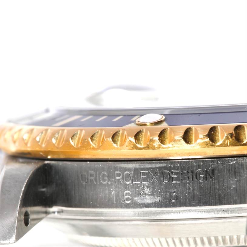 The image shows a close-up side view of the bezel and case of a Rolex Submariner 16613 Men's Steel and Gold (two tone) Blue Dial 16613 Men's Steel and Gold (two tone) Blue Dial watch, with engraving visible.