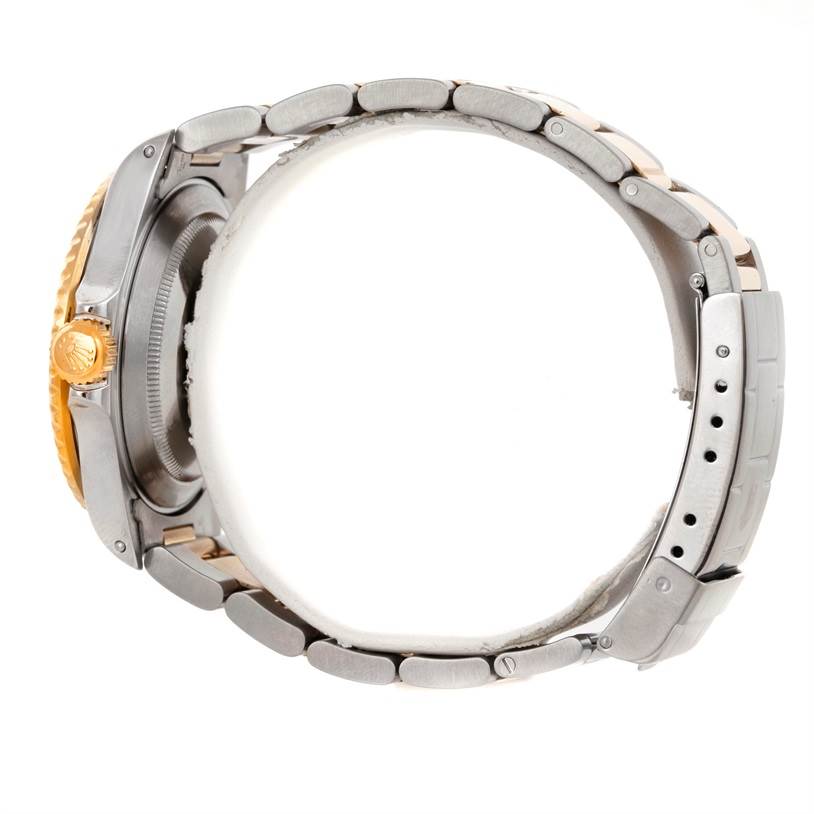 The image shows the side view of a Rolex Submariner 16613 Men's Steel and Gold (two tone) Blue Dial 16613 Men's Steel and Gold (two tone) Blue Dial, highlighting its crown, casing, and metal bracelet.