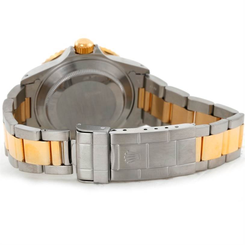 This image shows the back case and bracelet clasp of a Rolex Submariner 16613 Men's Steel and Gold (two tone) Blue Dial 16613 Men's Steel and Gold (two tone) Blue Dial watch, featuring a two-tone metal design.
