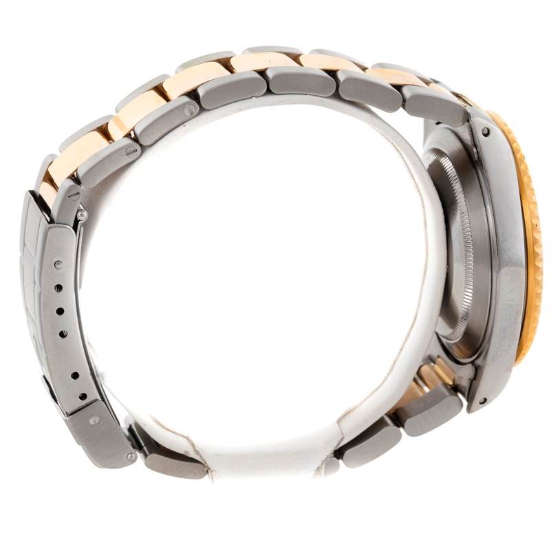 This image shows a side view of a Rolex Submariner 16613 Men's Steel and Gold (two tone) Blue Dial 16613 Men's Steel and Gold (two tone) Blue Dial watch, focusing on the bracelet and case.