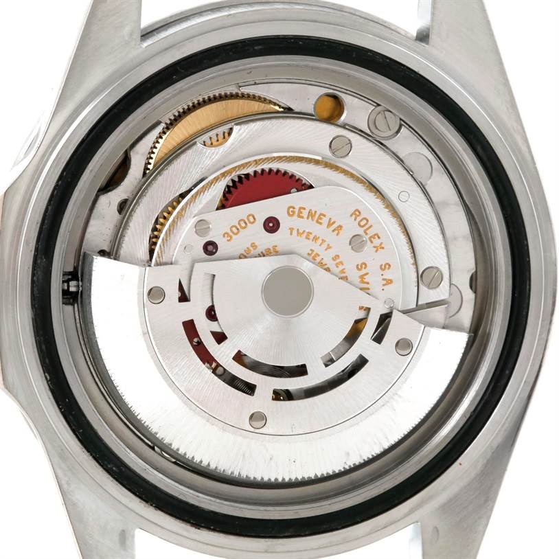 This image displays the Rolex Submariner 14060 Men
s Stainless Steel Black Dial 14060 Men
s Stainless Steel Black Dial
s internal movement from a rear angle, showcasing gears and the oscillating weight.