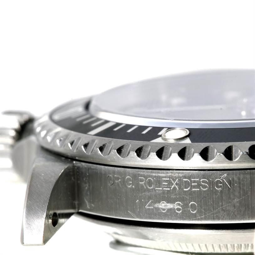 The image shows a side angle of the Rolex Submariner 14060 Men
s Stainless Steel Black Dial 14060 Men
s Stainless Steel Black Dial, highlighting the bezel, case, and partial crystal.