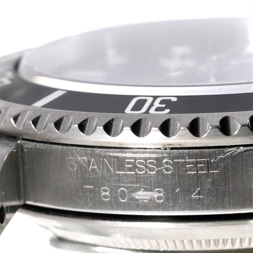 This image shows a close-up of the bezel and part of the case of a Rolex Submariner 14060 Men
s Stainless Steel Black Dial 14060 Men
s Stainless Steel Black Dial watch.