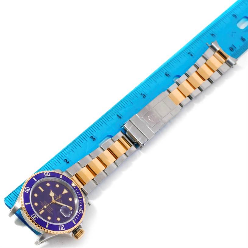 The image shows a Rolex Submariner 16803 Men's Steel and Gold (two tone) Blue Dial 16803 Men's Steel and Gold (two tone) Blue Dial watch laid flat with a ruler measuring the length of its two-tone bracelet.