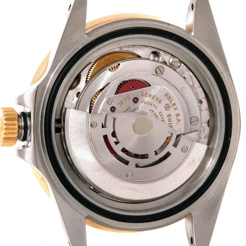 The image shows the internal mechanism of a Rolex Submariner 16803 Men's Steel and Gold (two tone) Blue Dial 16803 Men's Steel and Gold (two tone) Blue Dial watch, viewed from the case back.