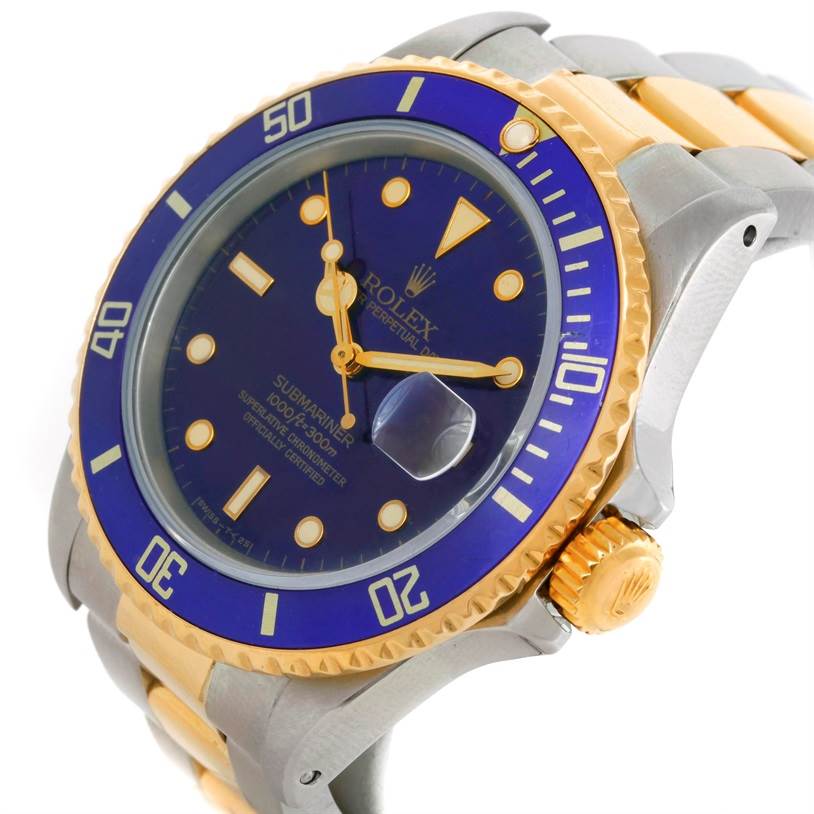 The image shows a close-up angled view of a Rolex Submariner 16803 Men's Steel and Gold (two tone) Blue Dial 16803 Men's Steel and Gold (two tone) Blue Dial, highlighting its blue dial, bezel, and two-tone metal bracelet.