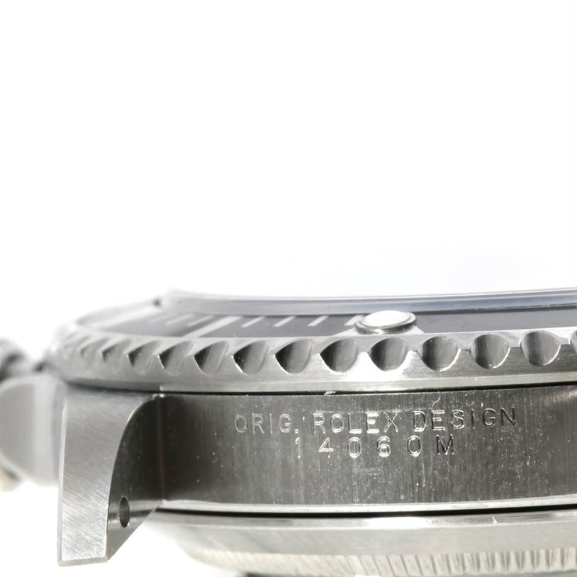 The image shows a close-up side view of the bezel and case of a Rolex Submariner 14060 Men
s Stainless Steel Black Dial 14060 Men
s Stainless Steel Black Dial watch, highlighting the engraving.
