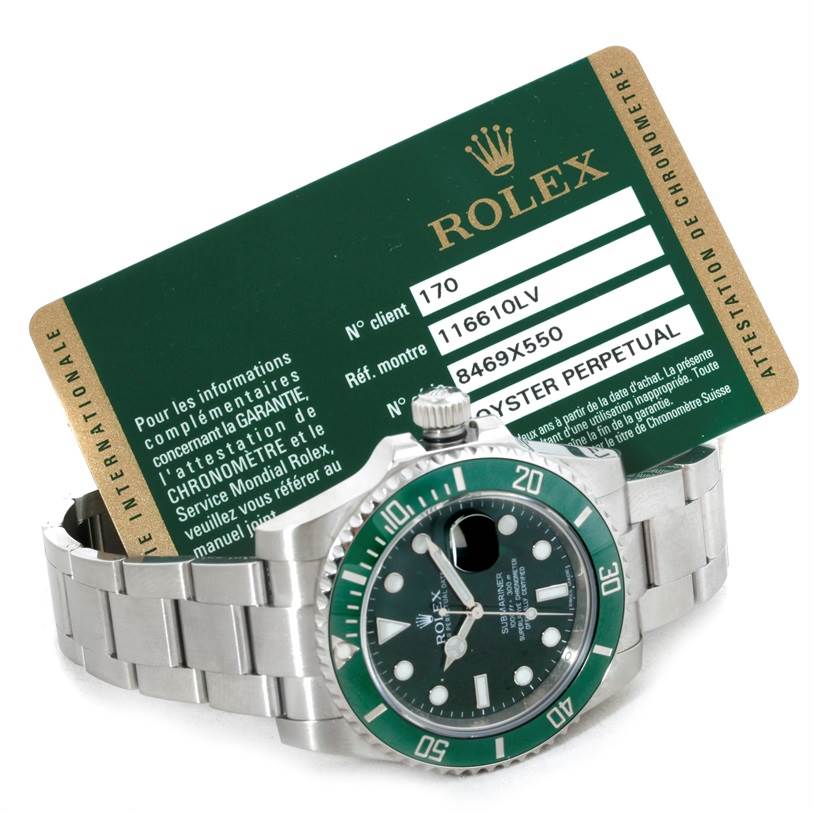 The image shows a Rolex Submariner 116610LV Men's Stainless Steel Green Dial 116610LV Men's Stainless Steel Green Dial watch with its green bezel and accompanying warranty card.