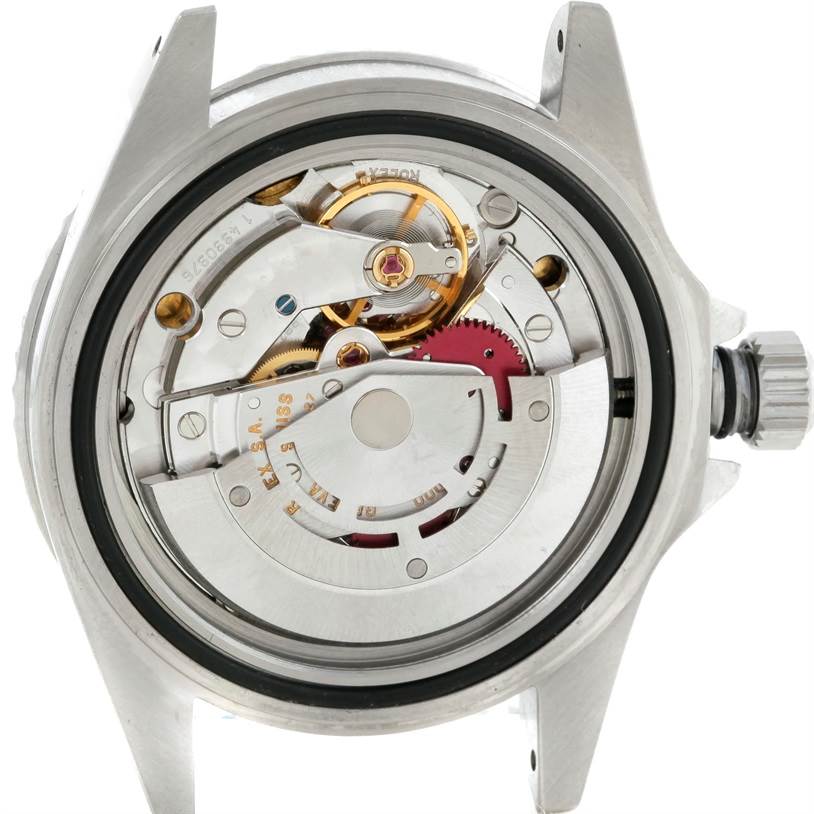 This image shows the movement and internal mechanisms of a Rolex Submariner 14060 Men
s Stainless Steel Black Dial 14060 Men
s Stainless Steel Black Dial watch from a rear angle with the back case removed.