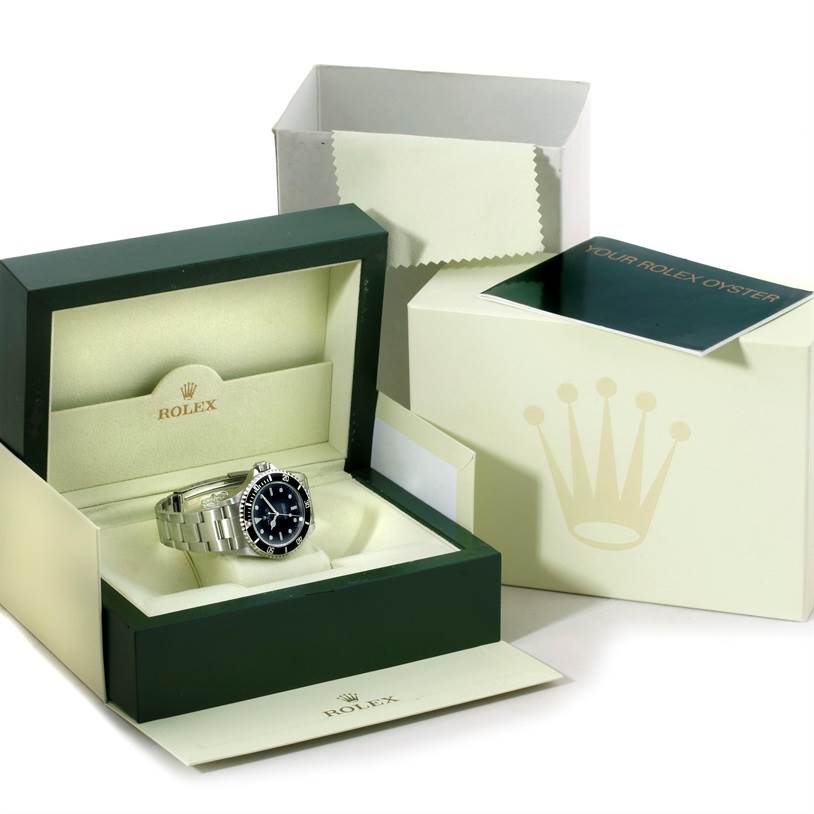 The image shows a Rolex Submariner 14060 Men
s Stainless Steel Black Dial 14060 Men
s Stainless Steel Black Dial watch in its box at a slight angle, along with outer packaging and papers.