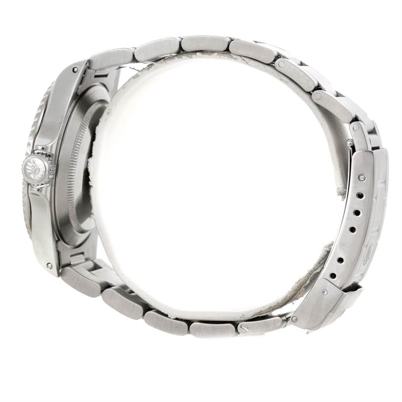 The image shows a side view of a Rolex Submariner 14060M Men
s Stainless Steel Black Dial 14060M Men
s Stainless Steel Black Dial watch, highlighting its case, crown, and metal bracelet with clasp.