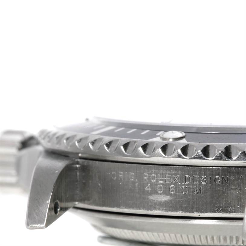 This image shows a side view of the bezel and case of a Rolex Submariner 14060M Men
s Stainless Steel Black Dial 14060M Men
s Stainless Steel Black Dial watch, highlighting the model engraving.