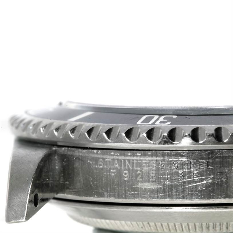 This image shows a close-up side view of the bezel and case of a Rolex Submariner 14060M Men
s Stainless Steel Black Dial 14060M Men
s Stainless Steel Black Dial watch in stainless steel.