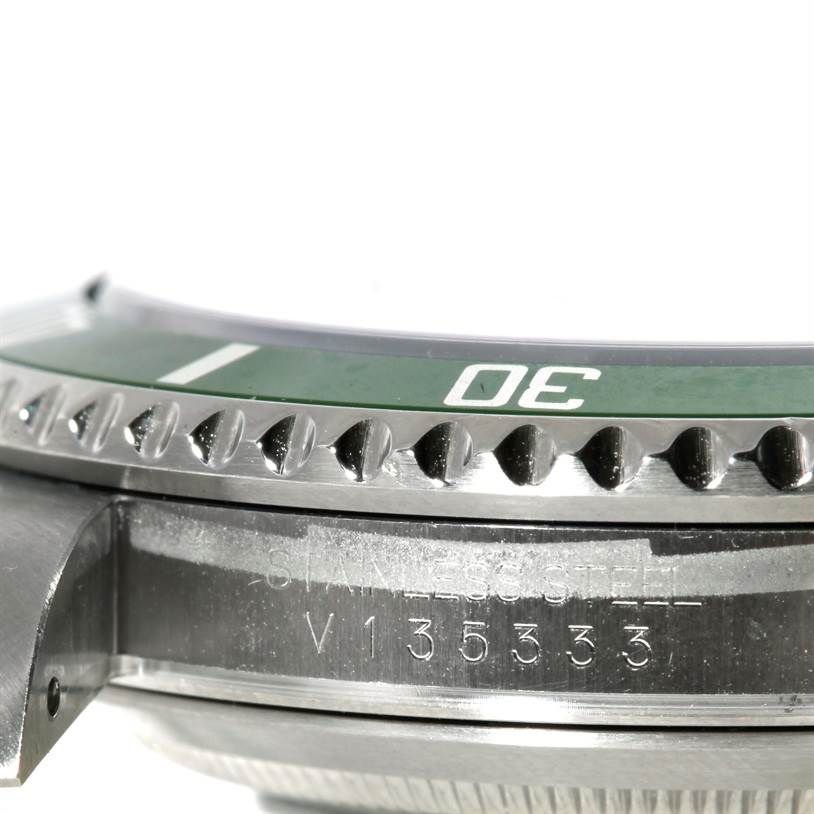 The image shows a close-up side angle of the Rolex Submariner 16610LV Men
s Stainless Steel Black Dial 16610LV Men
s Stainless Steel Black Dial
s bezel, case, and serial number engraving.