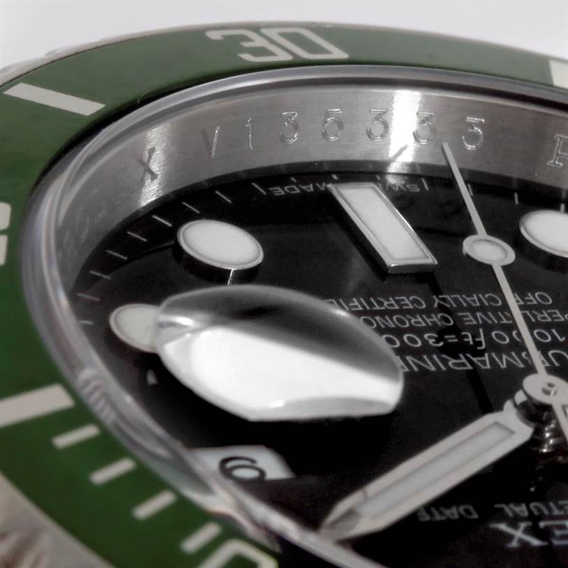 This close-up angle of the Rolex Submariner 16610LV Men
s Stainless Steel Black Dial 16610LV Men
s Stainless Steel Black Dial shows the green bezel, part of the black dial, and magnified date window.