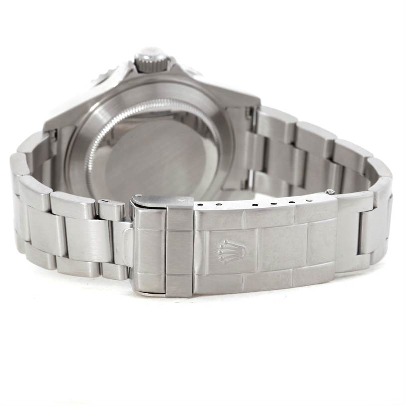 The image shows the back view of a Rolex Submariner 16610LV Men
s Stainless Steel Black Dial 16610LV Men
s Stainless Steel Black Dial watch, highlighting its case back and metal bracelet with the clasp.