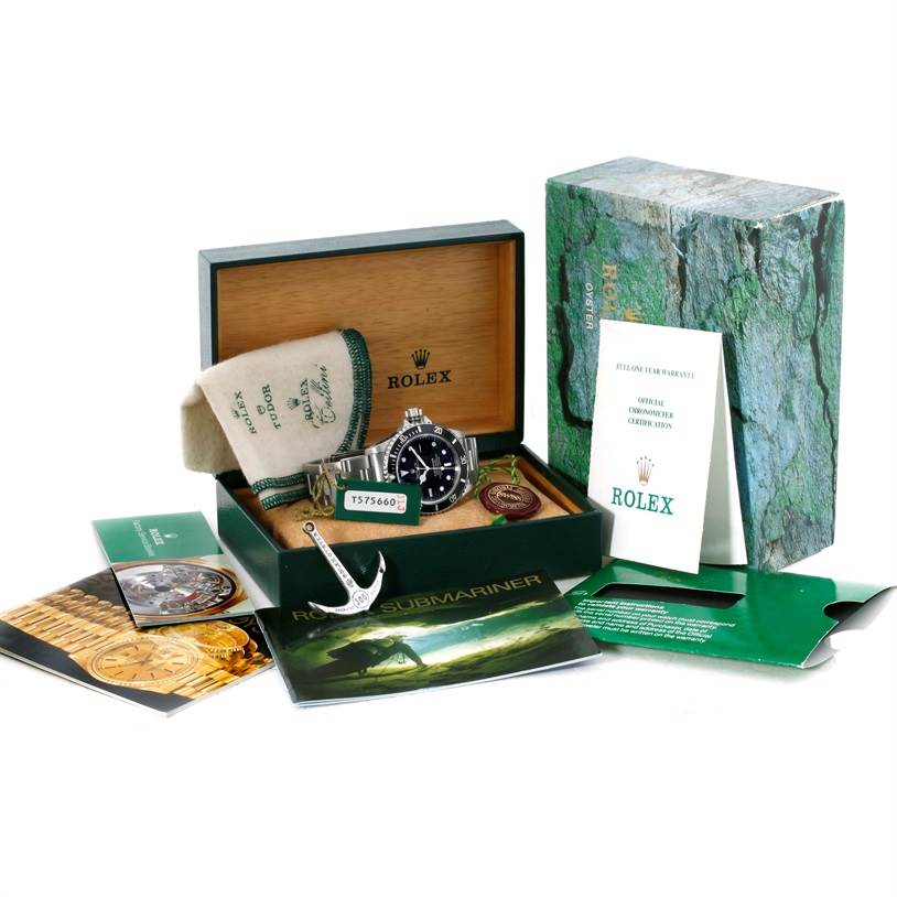 The image shows a Rolex Submariner 16610 Men
s Stainless Steel Black Dial 16610 Men
s Stainless Steel Black Dial watch with its box, manuals, warranty card, and other accessories from a frontal angle.