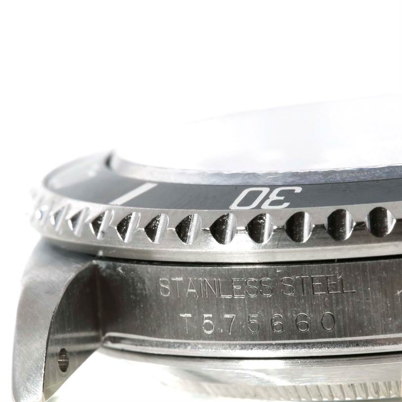 This image shows a close-up side view of the bezel and case, revealing the serial number and "STAINLESS STEEL" engraving of the Rolex Submariner 16610 Men
s Stainless Steel Black Dial 16610 Men
s Stainless Steel Black Dial.