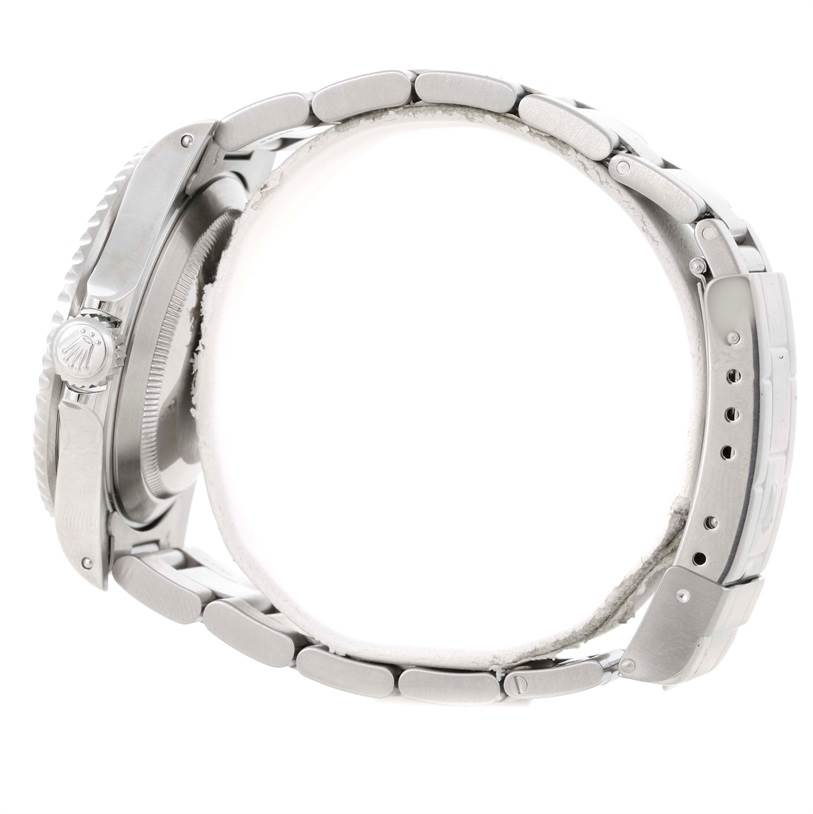 The image shows a side view of the Rolex Submariner 16610 Men
s Stainless Steel Black Dial 16610 Men
s Stainless Steel Black Dial watch, highlighting the crown and bracelet.