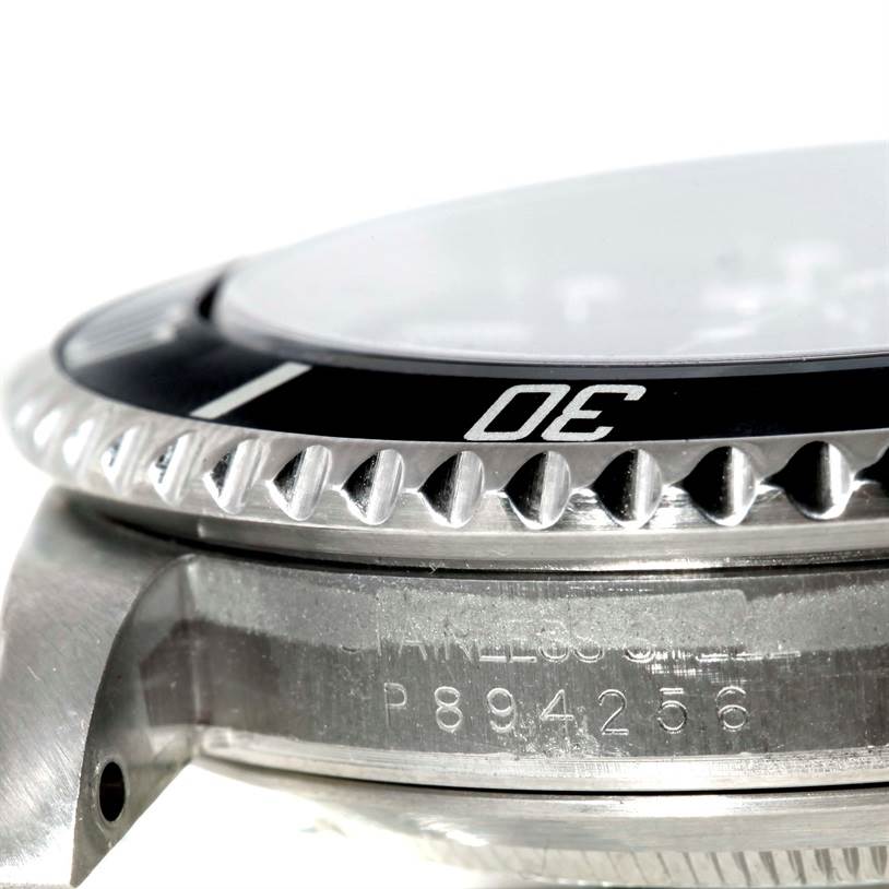 The image shows a close-up side view of the bezel, crystal, and case with etched details of the Rolex Submariner 16610 Men
s Stainless Steel Black Dial 16610 Men
s Stainless Steel Black Dial watch.