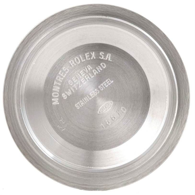 The image shows the inside case back of a Rolex Submariner 16610 Men
s Stainless Steel Black Dial 16610 Men
s Stainless Steel Black Dial watch model 16610, highlighting the inscriptions.
