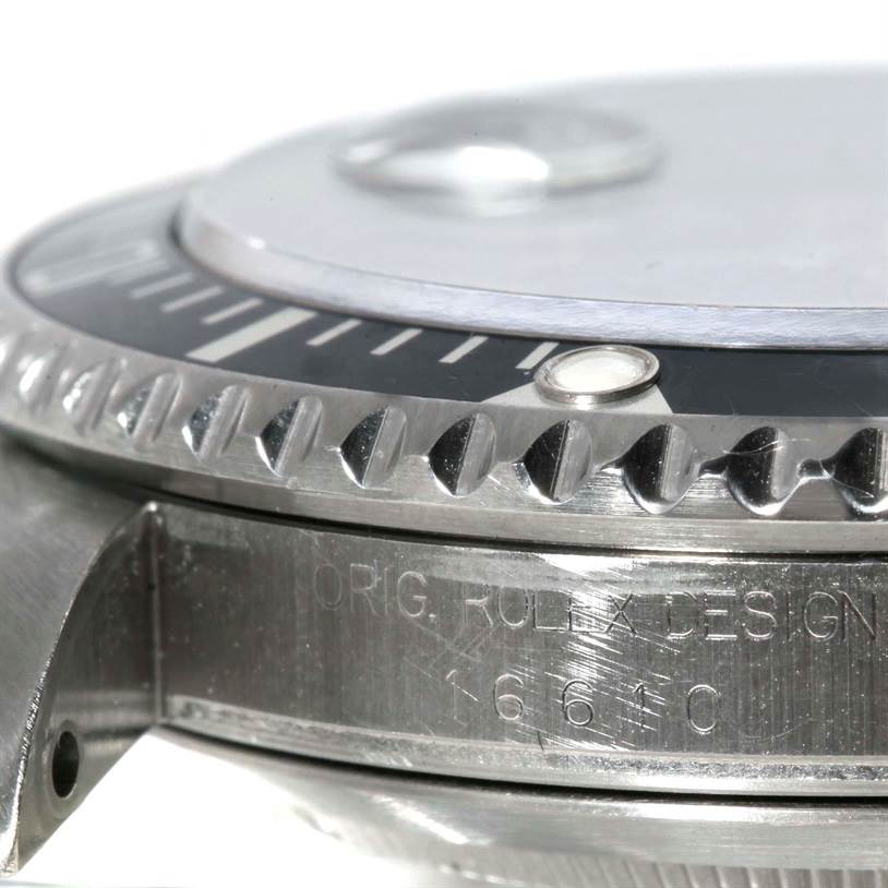 This close-up image shows the bezel, part of the dial, and engraved case of the Rolex Submariner 16610 Men
s Stainless Steel Black Dial 16610 Men
s Stainless Steel Black Dial model watch.
