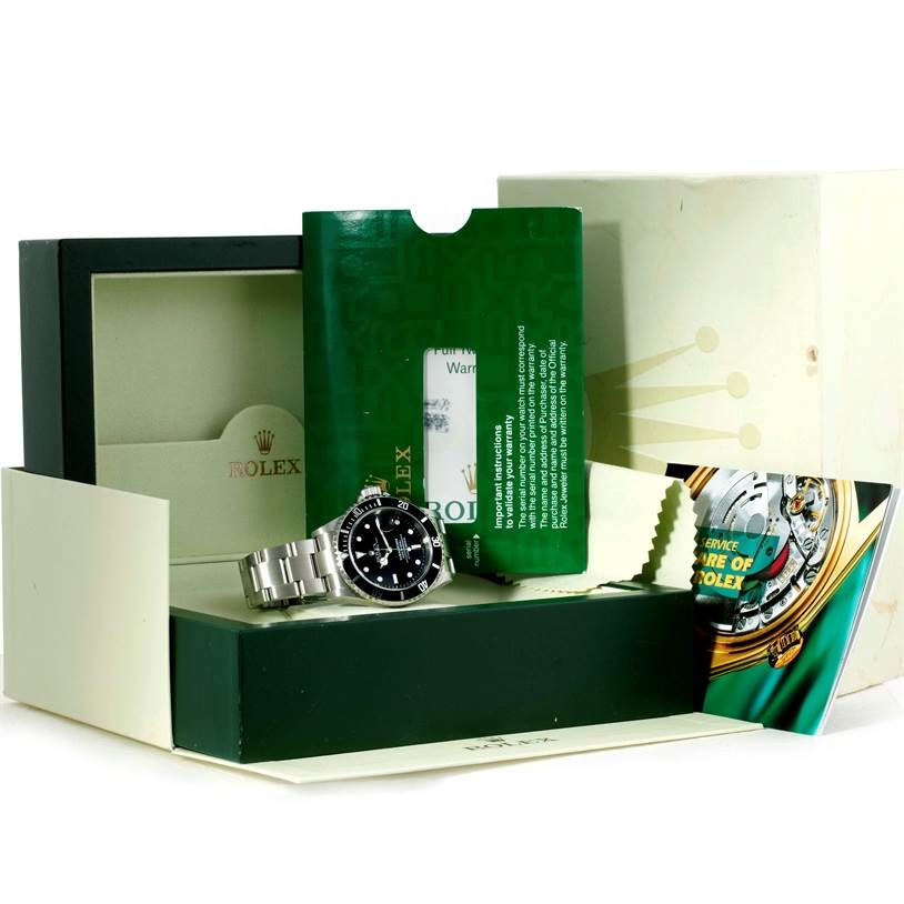 This image shows a Rolex Submariner 16610 Men
s Stainless Steel Black Dial 16610 Men
s Stainless Steel Black Dial watch, packaging, booklet, and warranty card.
