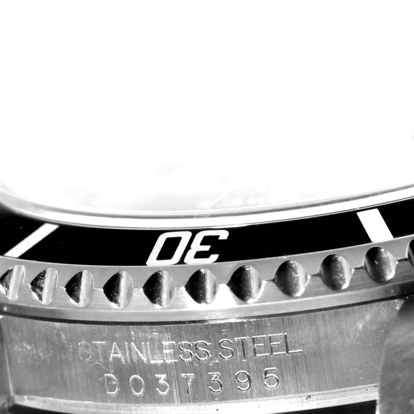 The image shows a close-up of the bezel and case of a Rolex Submariner 16610 Men
s Stainless Steel Black Dial 16610 Men
s Stainless Steel Black Dial watch, specifically highlighting the "30" marker and case serial number.