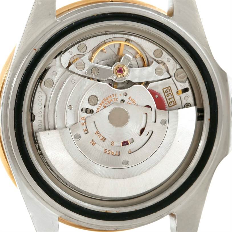 The image shows the inner workings and movement of a Rolex Submariner 16613 Men's Steel and Gold (two tone) Blue Dial 16613 Men's Steel and Gold (two tone) Blue Dial watch, viewed from the back.