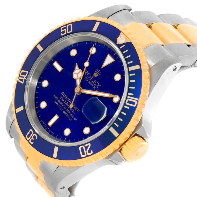 The image shows an angled view of a Rolex Submariner 16613 Men's Steel and Gold (two tone) Blue Dial 16613 Men's Steel and Gold (two tone) Blue Dial's face, bezel, crown, and bracelet.