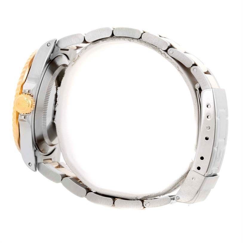 This image displays a Rolex Submariner 16613 Men's Steel and Gold (two tone) Blue Dial 16613 Men's Steel and Gold (two tone) Blue Dial watch from a side angle, showing the crown, case, and bracelet with clasp.