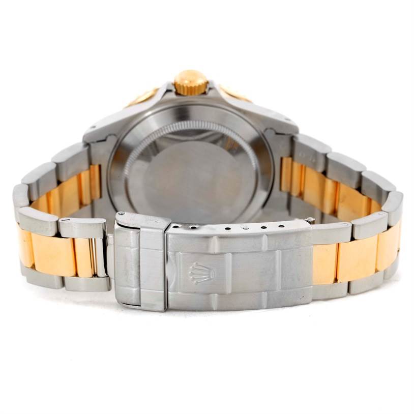 The image shows the back view of a Rolex Submariner 16613 Men's Steel and Gold (two tone) Blue Dial 16613 Men's Steel and Gold (two tone) Blue Dial with its clasp and bracelet clearly visible.