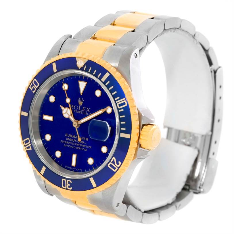 The image shows a Rolex Submariner 16613 Men's Steel and Gold (two tone) Blue Dial 16613 Men's Steel and Gold (two tone) Blue Dial watch at an angle highlighting the blue dial, bezel, and two-tone bracelet.