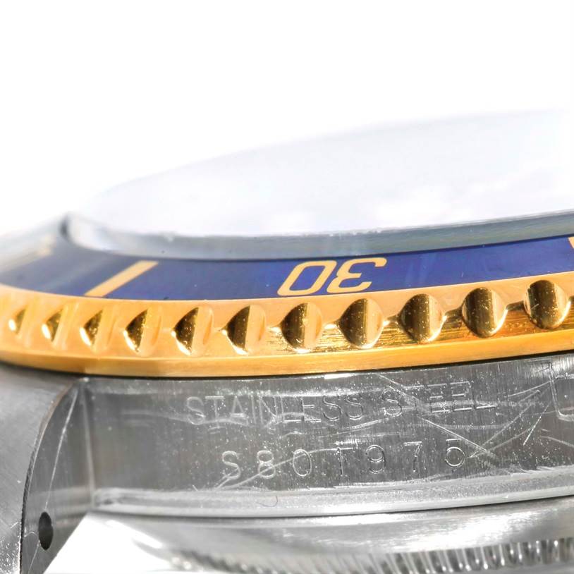 This close-up shows the side angle of the bezel and part of the case of a Rolex Submariner 16613 Men's Steel and Gold (two tone) Blue Dial 16613 Men's Steel and Gold (two tone) Blue Dial watch.