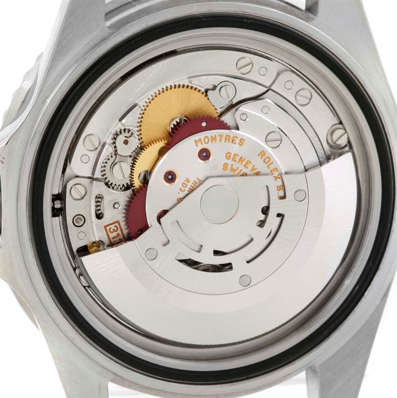 The image shows the back view of a Rolex Submariner 16610 Men
s Stainless Steel Black Dial 16610 Men
s Stainless Steel Black Dial watch, highlighting its intricate mechanical movement and components.