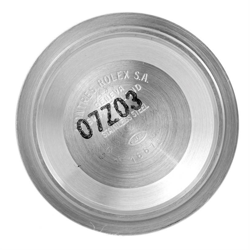 The image shows the interior case back of a Rolex Submariner 16610 Men
s Stainless Steel Black Dial 16610 Men
s Stainless Steel Black Dial watch, engraved with model information and serial number.