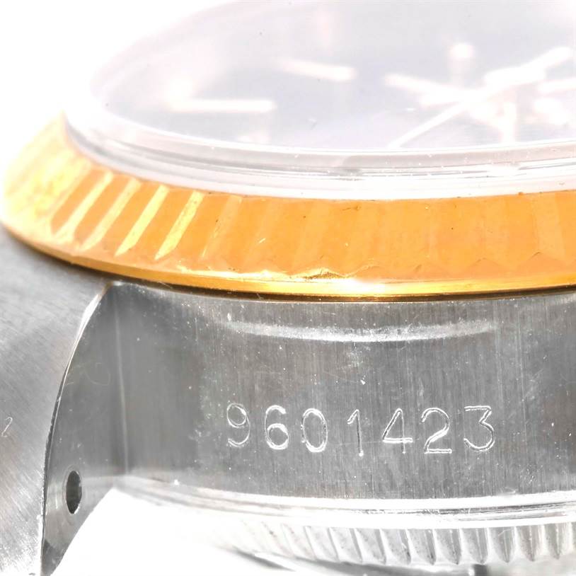 This close-up angle of the Rolex Datejust 69173 Women's Stainless Steel Black Dial 69173 Women's Stainless Steel Black Dial shows the serial number on the side of the watch case and part of the gold bezel.