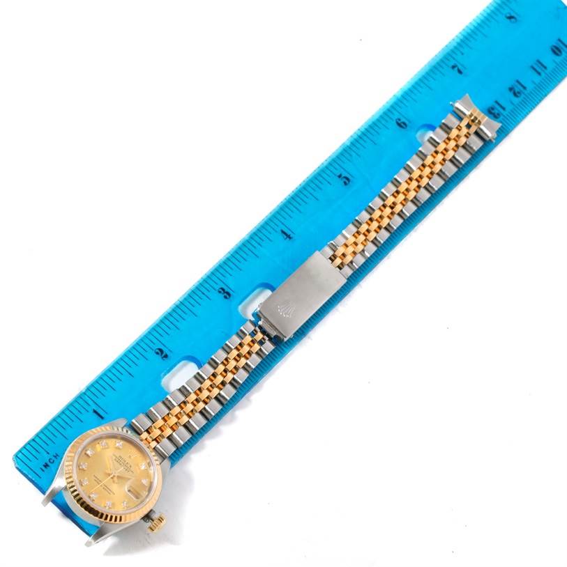 The image shows the Rolex Datejust 69173 Women's Stainless Steel Champagne Dial 69173 Women's Stainless Steel Champagne Dial watch face and metal bracelet alongside a blue ruler for measurement.