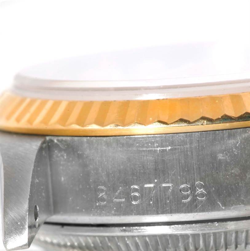 This close-up angle shows the side of a Rolex Datejust 69173 Women's Stainless Steel Champagne Dial 69173 Women's Stainless Steel Champagne Dial, highlighting the watch case, fluted bezel, and serial number.