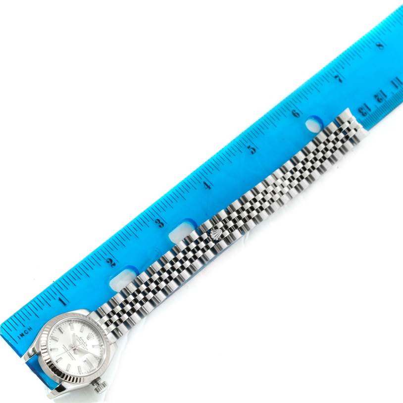 The image shows a Rolex Datejust 179174 Women
s Stainless Steel Silver Dial 179174 Women
s Stainless Steel Silver Dial watch lying flat, with the dial and metal bracelet visible, aligned with a blue ruler.