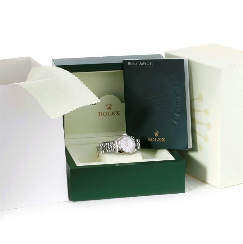 The image shows a Rolex Datejust 179174 Women
s Stainless Steel Silver Dial 179174 Women
s Stainless Steel Silver Dial watch in its open green box with accompanying booklet, cloth, and outer packaging.