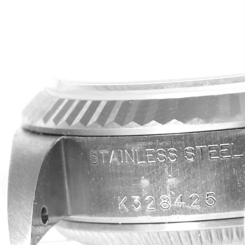 The close-up image shows the side of a Rolex Datejust 79174 Women's Stainless Steel White Dial 79174 Women's Stainless Steel White Dial watch, featuring part of the case with the engravings "STAINLESS STEEL" and "K328425."
