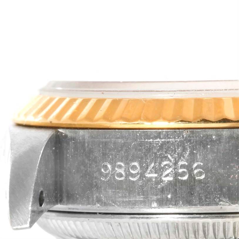 The image shows a close-up side view of the Rolex Datejust 69173 Women's Stainless Steel Champagne Dial 69173 Women's Stainless Steel Champagne Dial watch, focusing on the bezel and serial number.