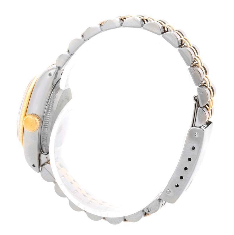 This side profile of the Rolex Datejust 69173 Women's Stainless Steel Champagne Dial 69173 Women's Stainless Steel Champagne Dial watch shows the case, crown, and part of the metal bracelet.