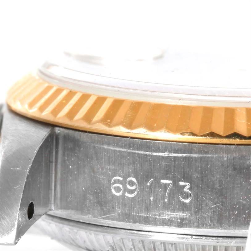 This image shows a close-up of the side of a Rolex Datejust 69173 Women's Stainless Steel Champagne Dial 69173 Women's Stainless Steel Champagne Dial watch case, highlighting the reference number and the fluted bezel.