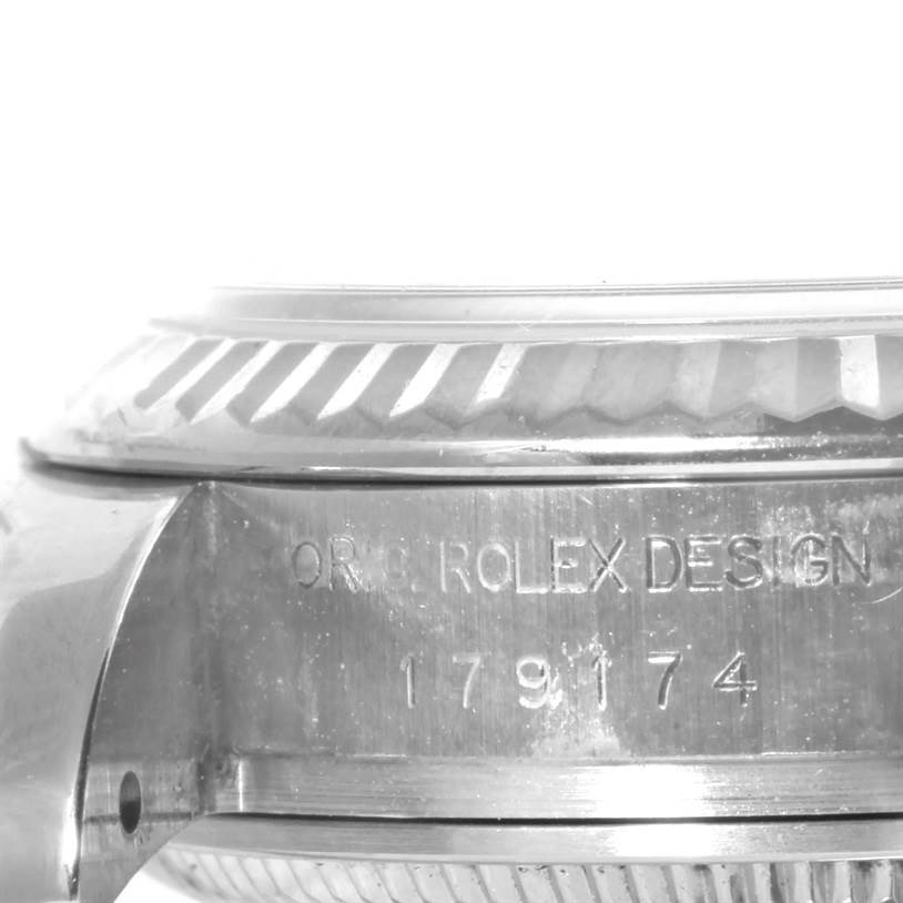 This image shows a close-up of the side case and fluted bezel of a Rolex Datejust 179174 Women's Stainless Steel Pink Dial 179174 Women's Stainless Steel Pink Dial model.