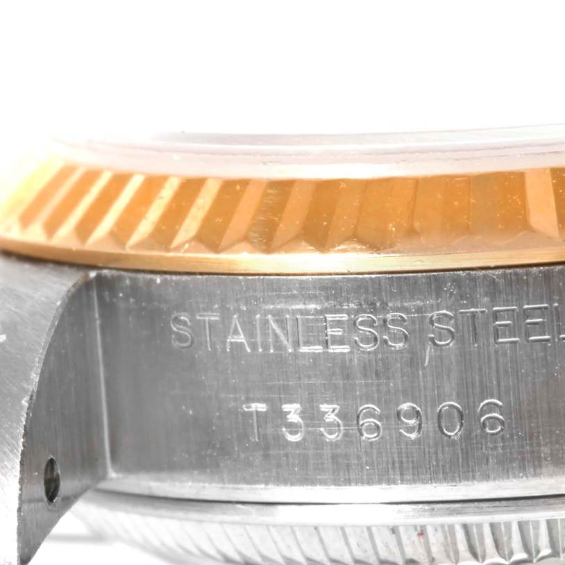 This image shows a close-up of the side of a Rolex Datejust 69173 Women's Stainless Steel Champagne Dial 69173 Women's Stainless Steel Champagne Dial watch, highlighting its stainless steel casing and the fluted bezel.