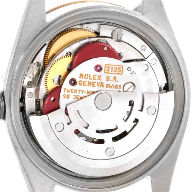 The image shows the inner mechanism of a Rolex Datejust 69173 Women's Stainless Steel Champagne Dial 69173 Women's Stainless Steel Champagne Dial model, focusing on the movement and gears.