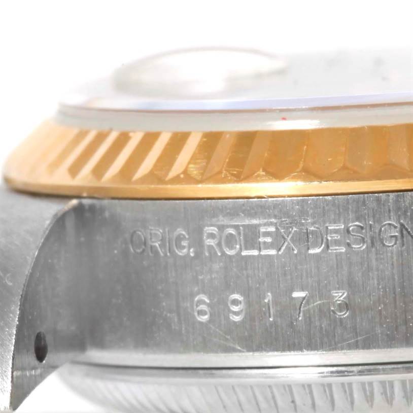 The image shows a close-up of the side profile of a Rolex Datejust 69173 Women's Stainless Steel Champagne Dial 69173 Women's Stainless Steel Champagne Dial watch, highlighting the serial number and part of the bezel.